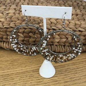 Large silver hoop earrings with brown &white beads